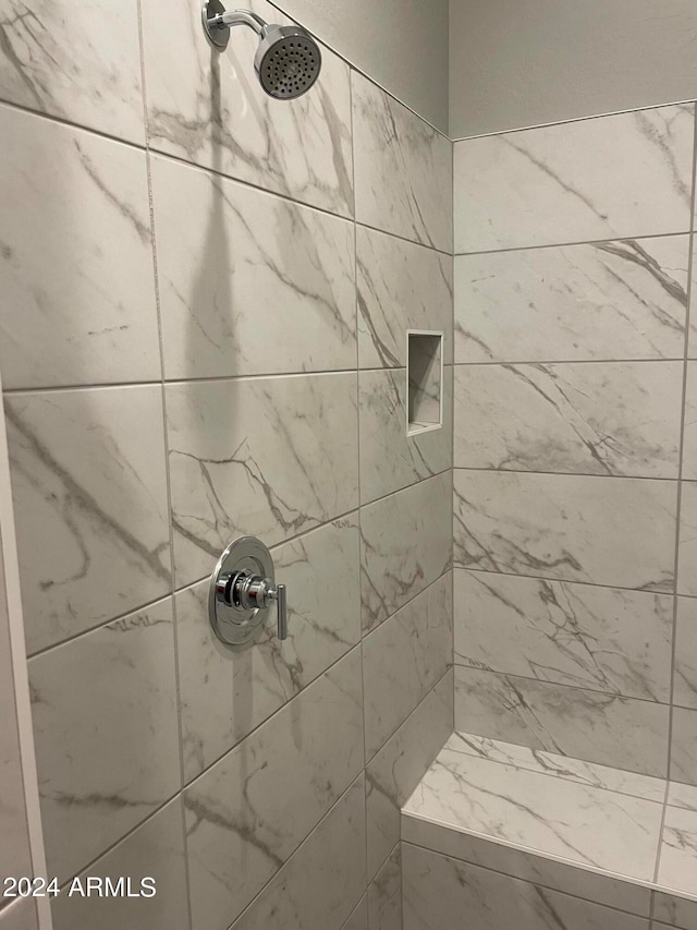 full bathroom with tiled shower