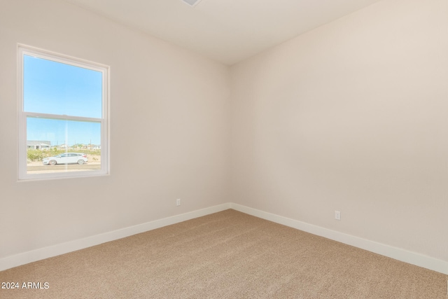 empty room featuring carpet flooring and baseboards