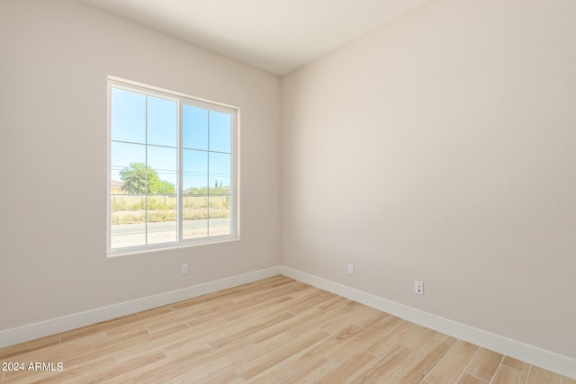 empty room with light wood-style floors and baseboards