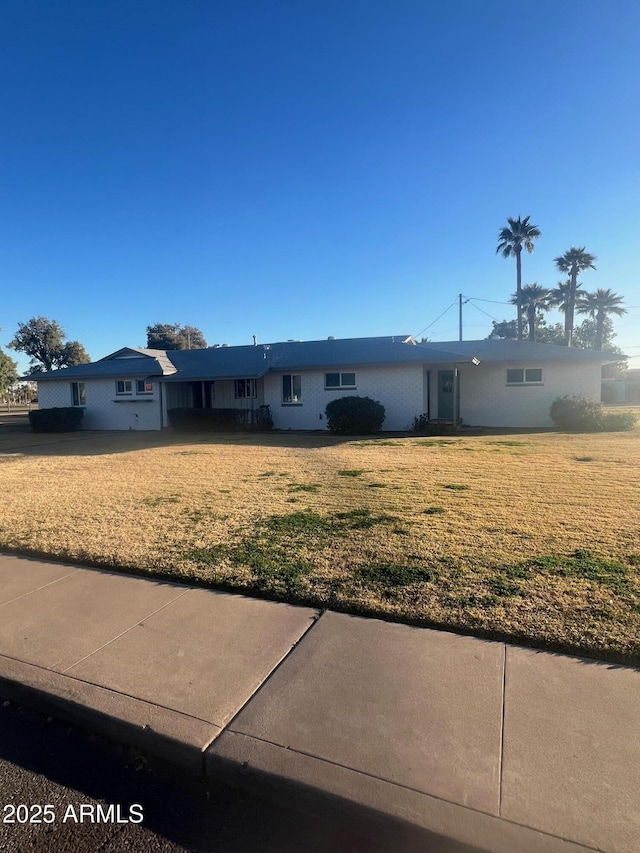 ranch-style house with a front lawn