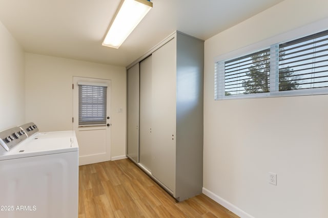 laundry room with light wood-type flooring and independent washer and dryer