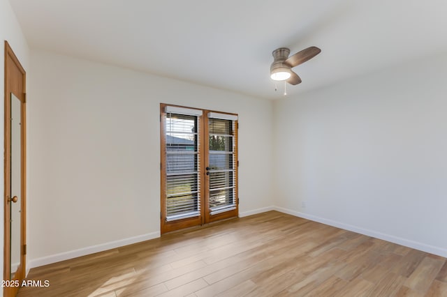 empty room featuring ceiling fan and light hardwood / wood-style flooring