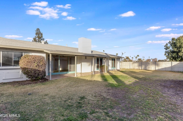 back of property featuring a lawn