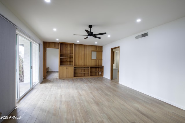 unfurnished living room featuring ceiling fan and light hardwood / wood-style flooring