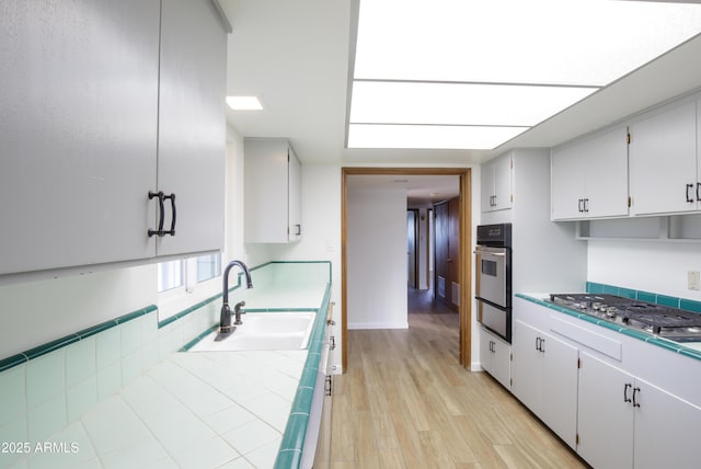 kitchen featuring white cabinets, sink, and appliances with stainless steel finishes