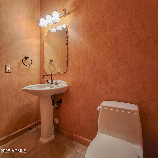 bathroom with tile patterned flooring and toilet