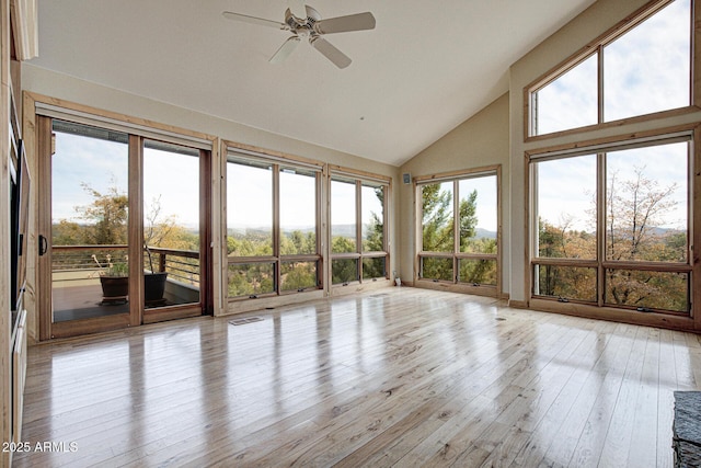 unfurnished sunroom featuring ceiling fan and vaulted ceiling