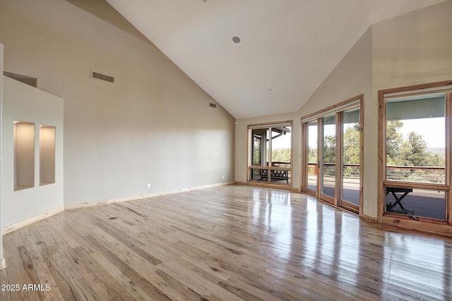 interior space with high vaulted ceiling and light wood-type flooring