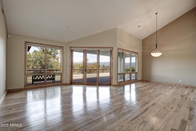 interior space with high vaulted ceiling and light wood-type flooring