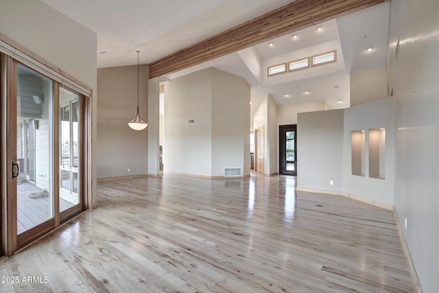 unfurnished room featuring high vaulted ceiling, beam ceiling, and light hardwood / wood-style floors