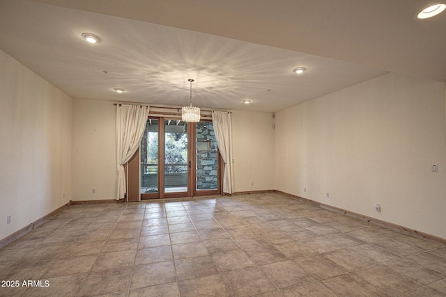 unfurnished room with an inviting chandelier