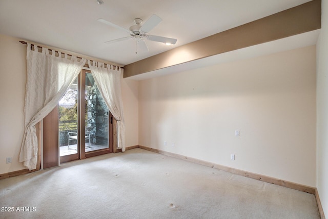 unfurnished room with ceiling fan and carpet