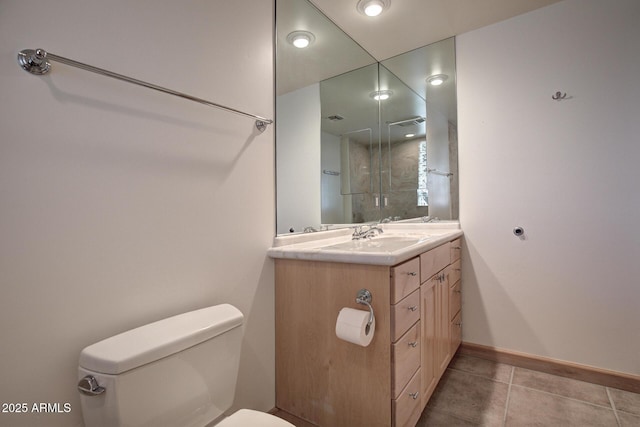 bathroom with vanity, tile patterned floors, and toilet