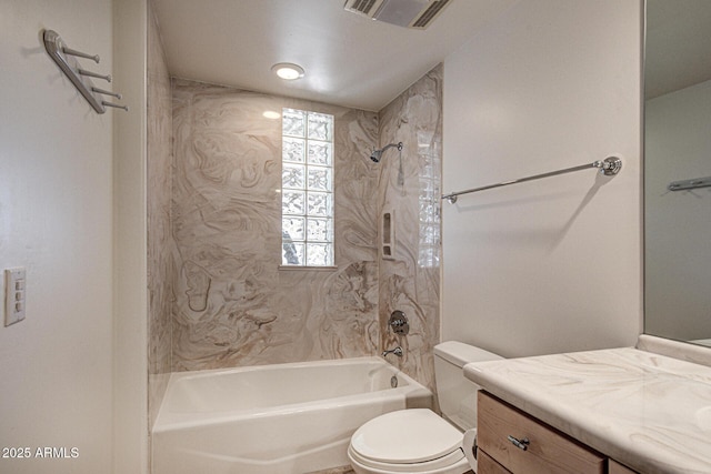 full bathroom with vanity, tiled shower / bath combo, and toilet