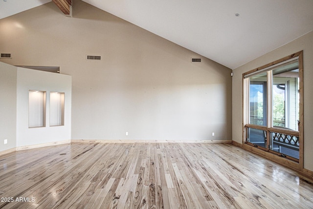 unfurnished living room with light hardwood / wood-style flooring, high vaulted ceiling, and beamed ceiling