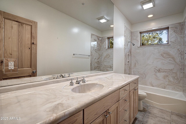 full bathroom featuring vanity, tiled shower / bath, tile patterned floors, and toilet