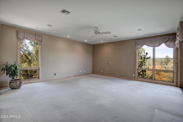 unfurnished room with light carpet and ceiling fan