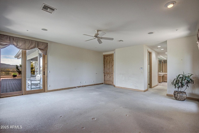 unfurnished room featuring ceiling fan and light colored carpet