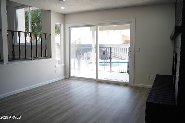 1632 E Saint Charles Ave, Phoenix, AZ 85042 - unfurnished dining area with wood finished floors, a textured ceiling, and stairs