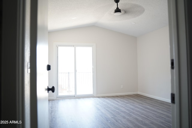1632 E Saint Charles Ave, Phoenix, AZ 85042 - unfurnished room featuring plenty of natural light, lofted ceiling, a textured ceiling, and wood finished floors