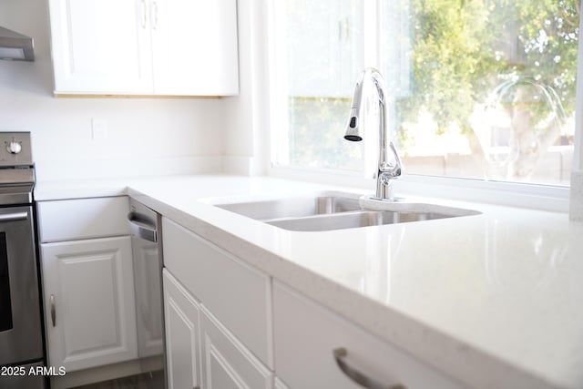 1632 E Saint Charles Ave, Phoenix, AZ 85042 - kitchen with range, extractor fan, white cabinets, and light countertops