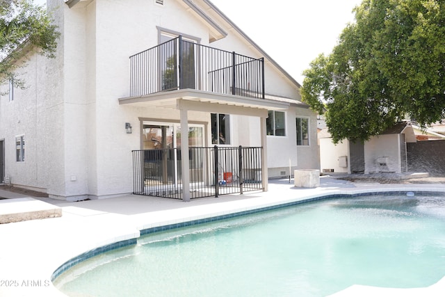 1632 E Saint Charles Ave, Phoenix, AZ 85042 - back of property with a balcony, a patio area, stucco siding, and an outdoor pool