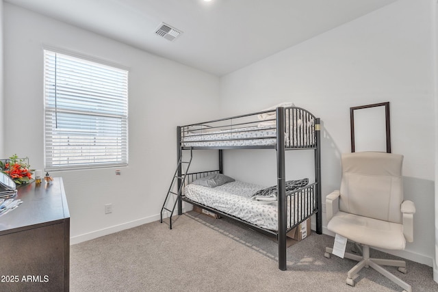 bedroom with light carpet, visible vents, and baseboards