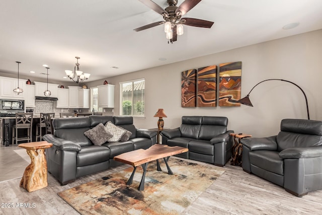 1078 W Redwood Ave, Queen Creek, AZ 85140 - living room featuring ceiling fan with notable chandelier and light wood-style floors