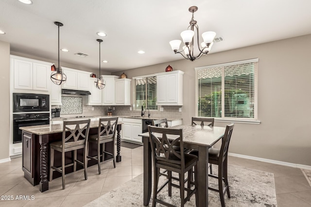 1078 W Redwood Ave, Queen Creek, AZ 85140 - dining area featuring light tile patterned flooring, baseboards, visible vents, and an inviting chandelier