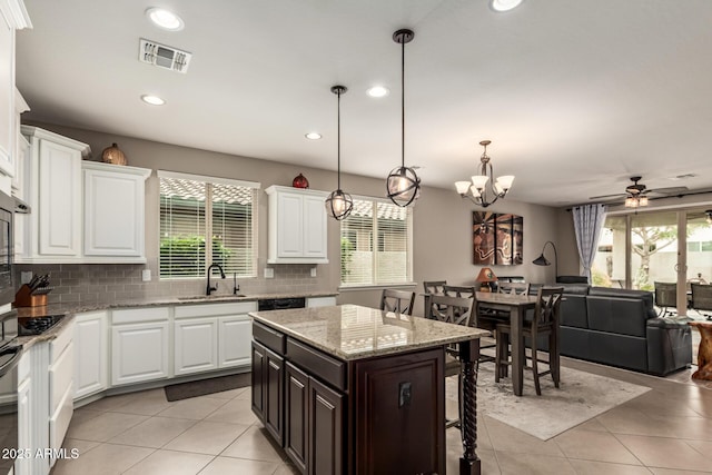 1078 W Redwood Ave, Queen Creek, AZ 85140 - kitchen featuring a kitchen breakfast bar, tasteful backsplash, light tile patterned floors, a sink, and visible vents