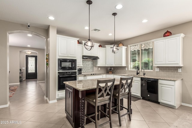 1078 W Redwood Ave, Queen Creek, AZ 85140 - kitchen featuring white cabinets, tasteful backsplash, a sink, black appliances, and light tile patterned floors