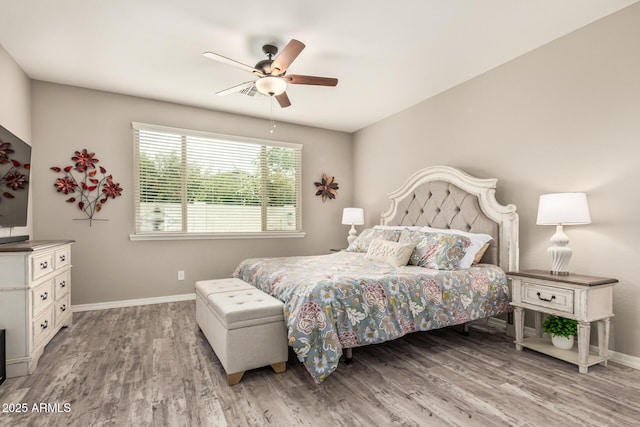 1078 W Redwood Ave, Queen Creek, AZ 85140 - bedroom with baseboards, wood finished floors, and a ceiling fan