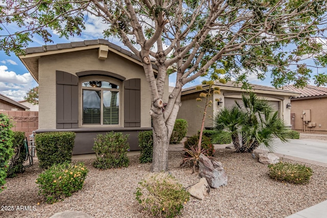1078 W Redwood Ave, Queen Creek, AZ 85140 - view of front of home featuring a garage, concrete driveway, stucco siding, and fence