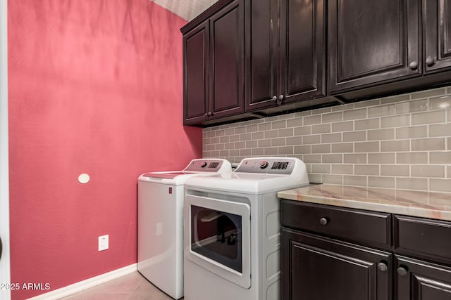 1078 W Redwood Ave, Queen Creek, AZ 85140 - laundry room with washing machine and clothes dryer, cabinet space, baseboards, and light tile patterned flooring