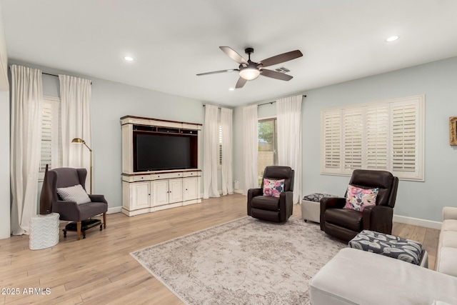 living area with light wood-style floors, ceiling fan, recessed lighting, and baseboards