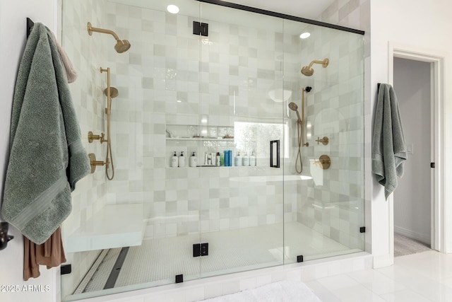 bathroom with a stall shower and baseboards