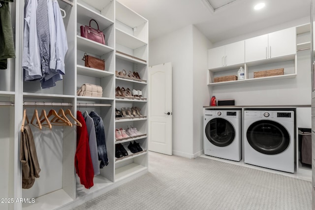 laundry area featuring washing machine and dryer, carpet floors, attic access, and baseboards