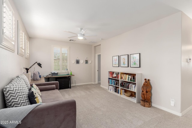 living area with carpet floors, ceiling fan, and baseboards