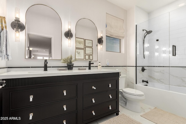 bathroom with toilet, double vanity, shower / washtub combination, and marble finish flooring