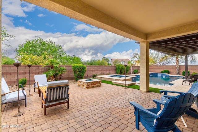 view of patio with a fenced backyard and a pool with connected hot tub