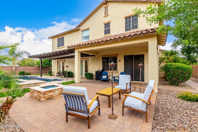 back of property with stucco siding, a pergola, a patio area, and a fenced backyard