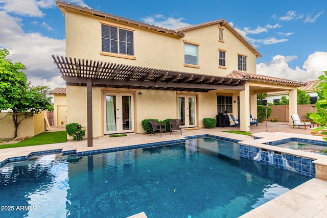 back of property with french doors, a pergola, stucco siding, and fence