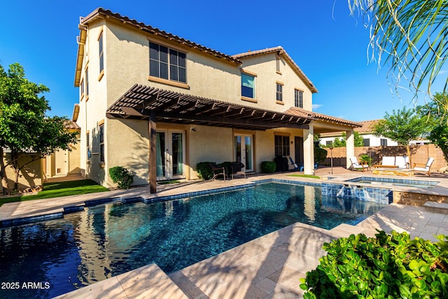 back of property with french doors, fence, stucco siding, and a tiled roof
