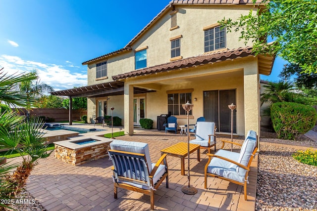 back of property featuring stucco siding, a pergola, a fenced backyard, and a patio area