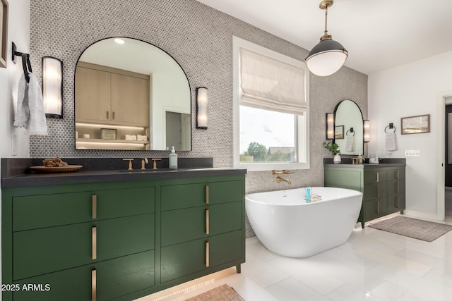 bathroom featuring a soaking tub, two vanities, tile patterned floors, and backsplash