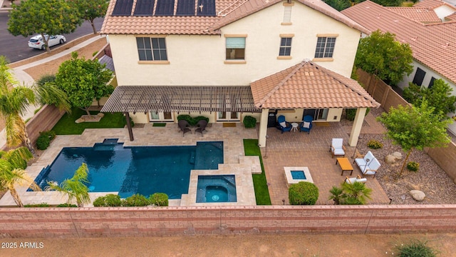 aerial view of property and surrounding area with a pool area