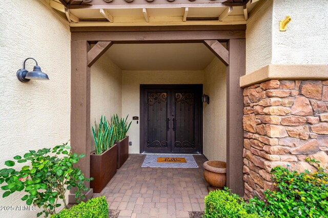 property entrance with stucco siding