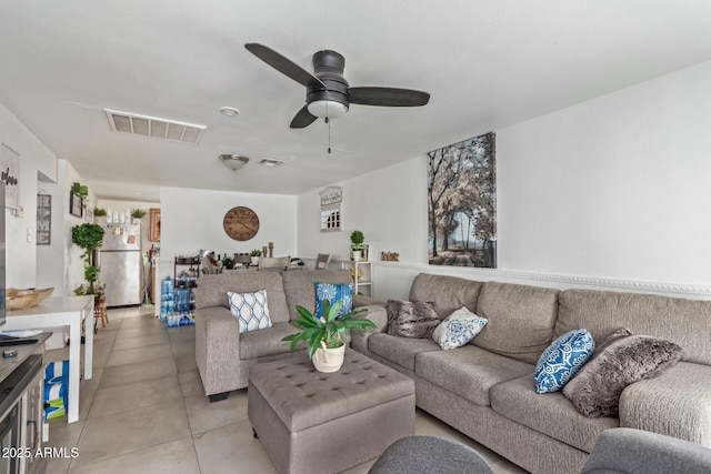 living area featuring visible vents, ceiling fan, and light tile patterned flooring