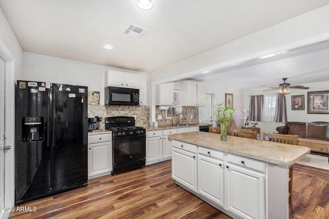 2419 E Billings St, Mesa, AZ 85213 - kitchen with black appliances, a sink, decorative backsplash, white cabinetry, and recessed lighting