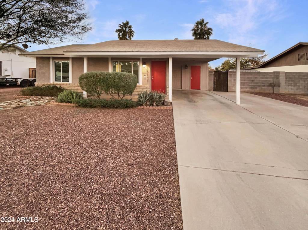 ranch-style home with a carport